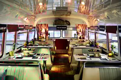 the interior of the red bus bistro set up for afternoon tea