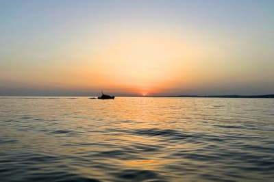 Boat in the sea with the sun setting