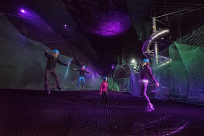 people bouncing on the trampolines underground at zip worlds bounce below