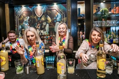 three ladies mixing cocktails on a cocktail masterclass at revolucion de cuba