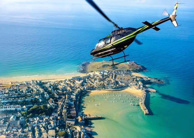 helicopter flying over the cornish coastline