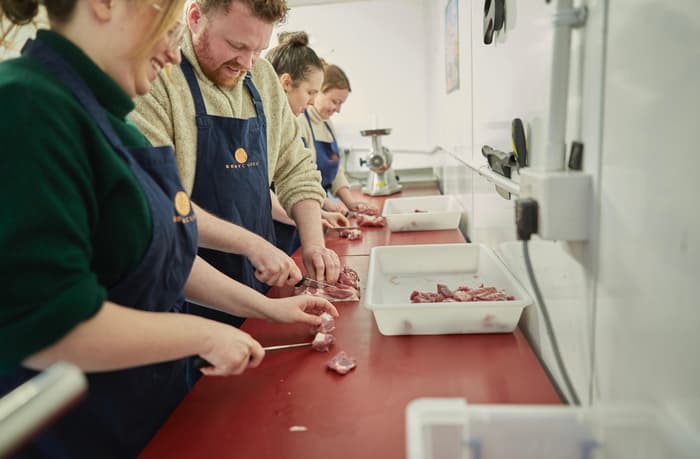 learning butchery skills on a sausage making class
