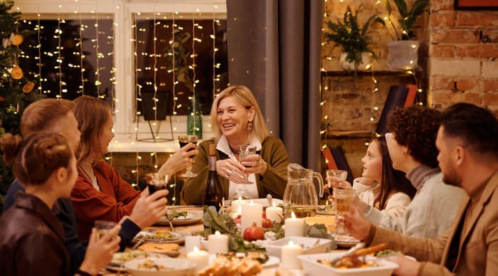 A family enjoying christmas dinner around the table