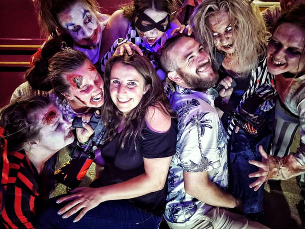 two people surrounded by zombies s part of a zombie birthday gift experience