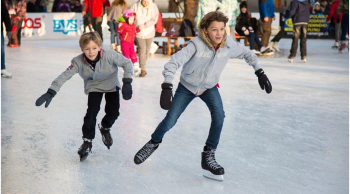 Kids ice skating at christmas