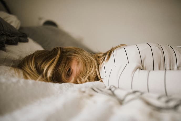Woman in bed with coffee