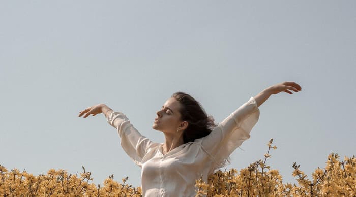 Woman throwing her hair back in the sunshine
