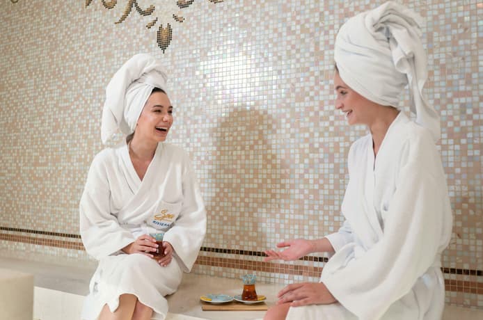 Women wearing sunglasses and head towels