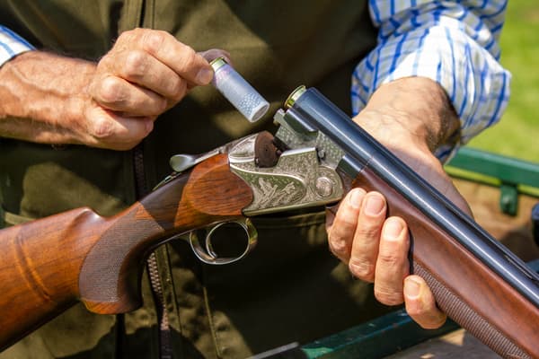 a man reloading a gun as part of a clay pigeon shooting experience available nationally