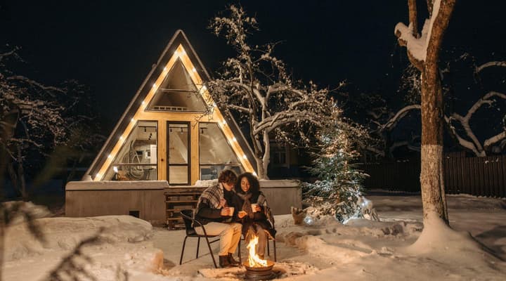 Couple sitting outside by the fire in winter