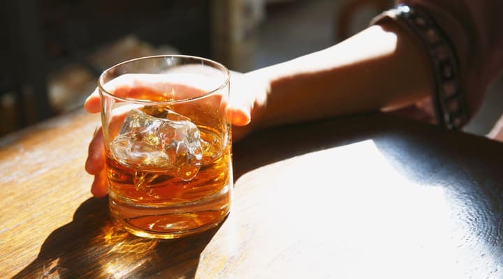 Glass of whisky on a wooden table