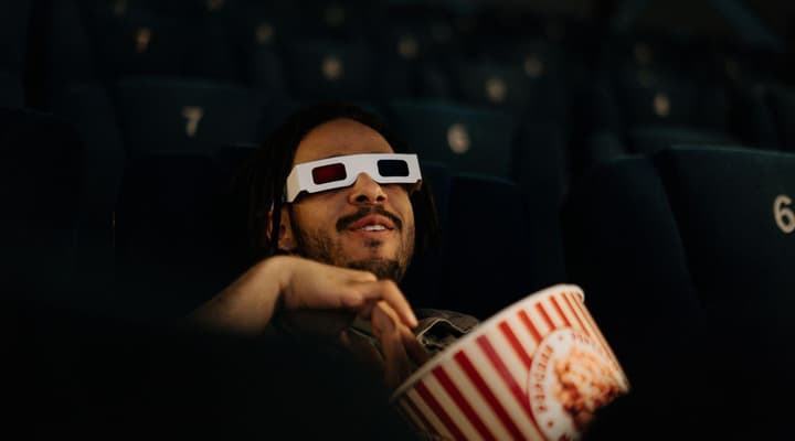 Man wearing 3d glasses watching film in cinema