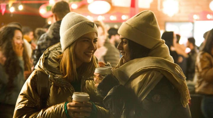 Two women dressed for winter at a christmas market