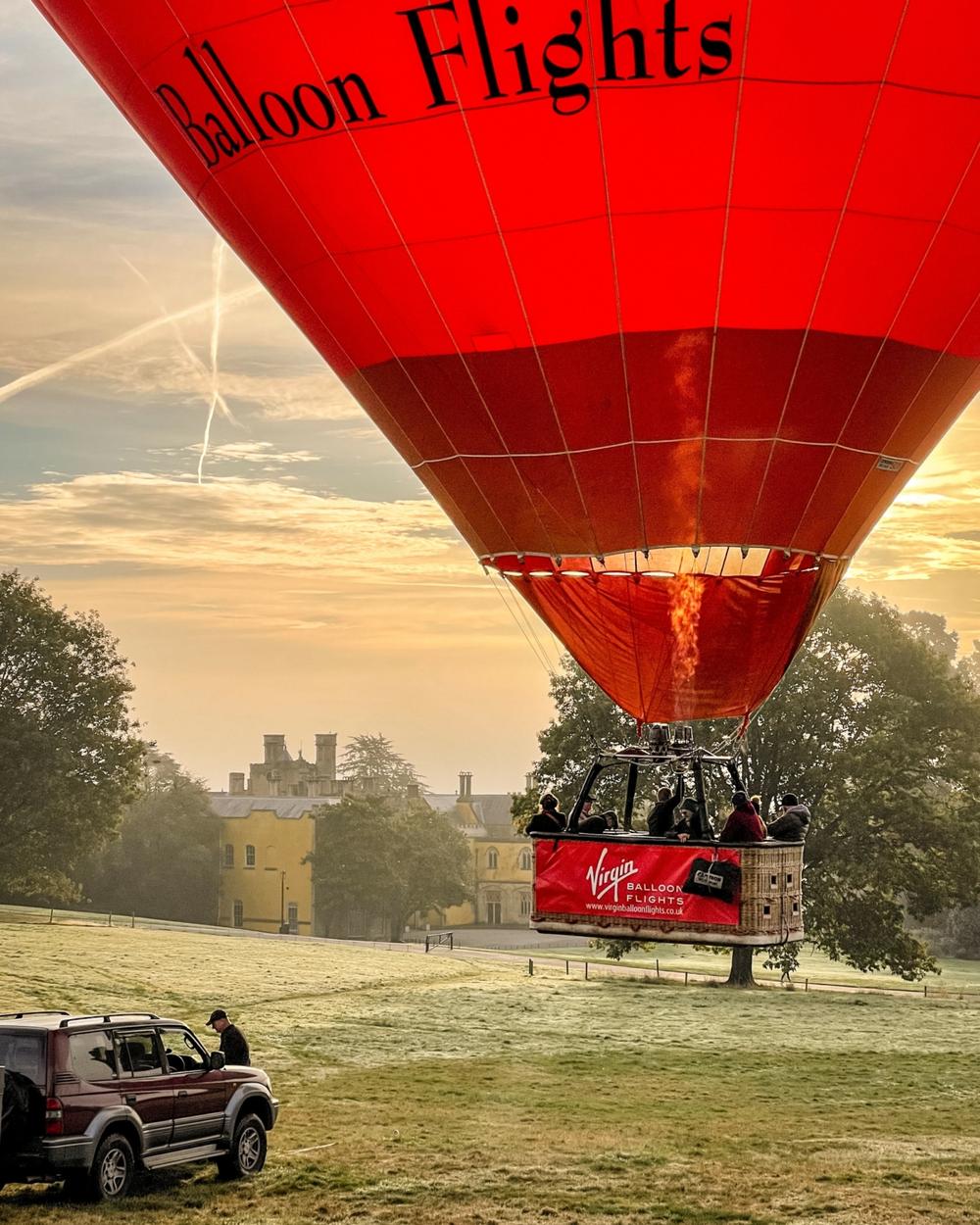 hot air balloon taking off just above ground