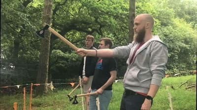man preparing to throw an axe at the target on an axe throwing experience day