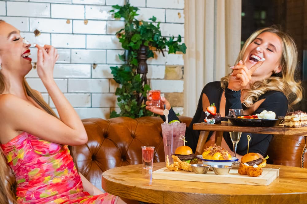 2 women laughing while at afternoon tea