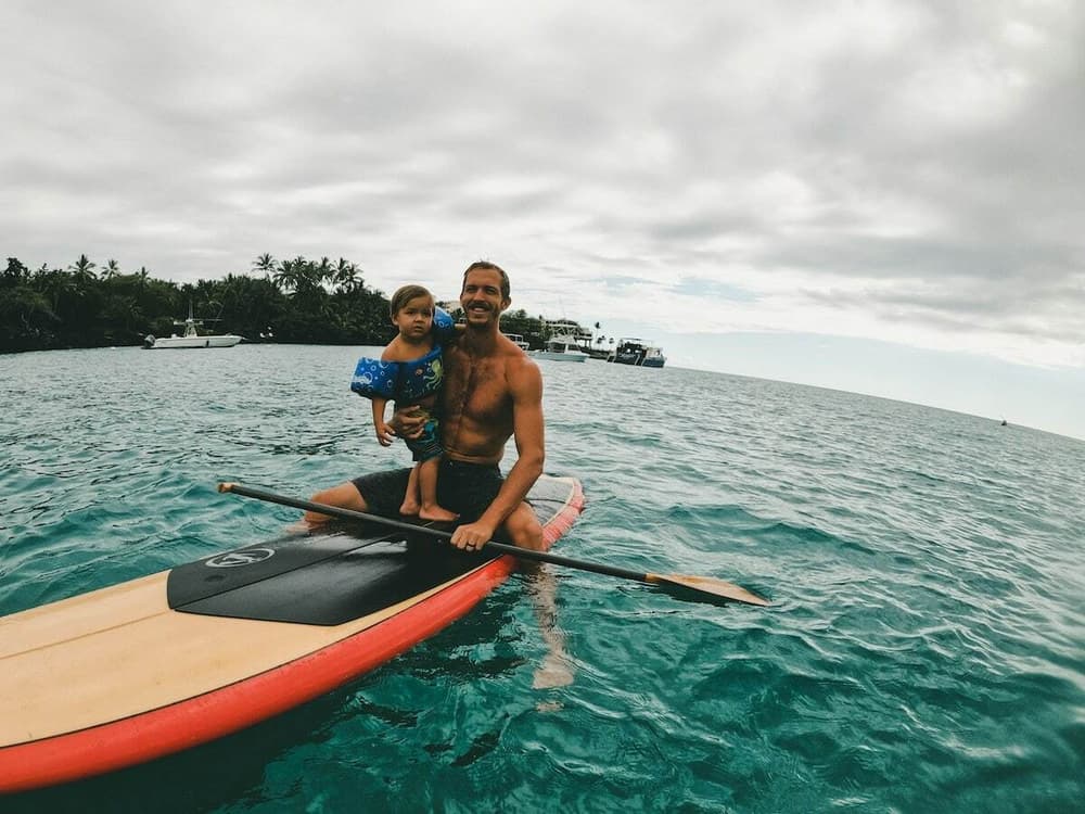 Dad and child on a paddleboard