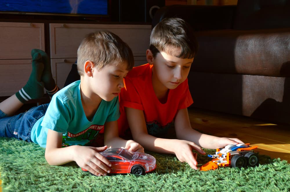 Kids playing with toy cars