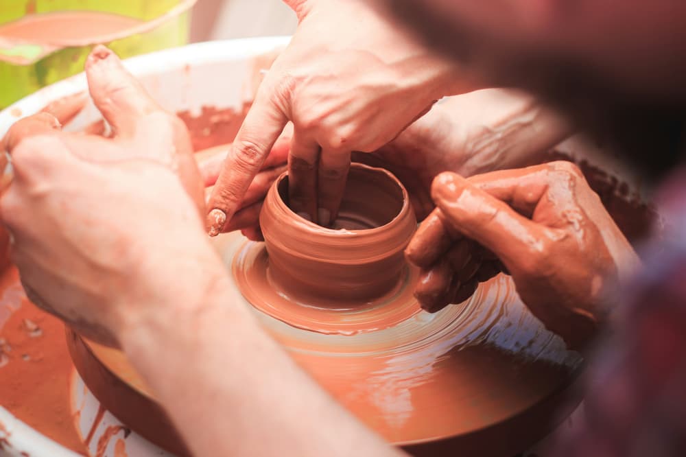 Man and woman crafting a pot