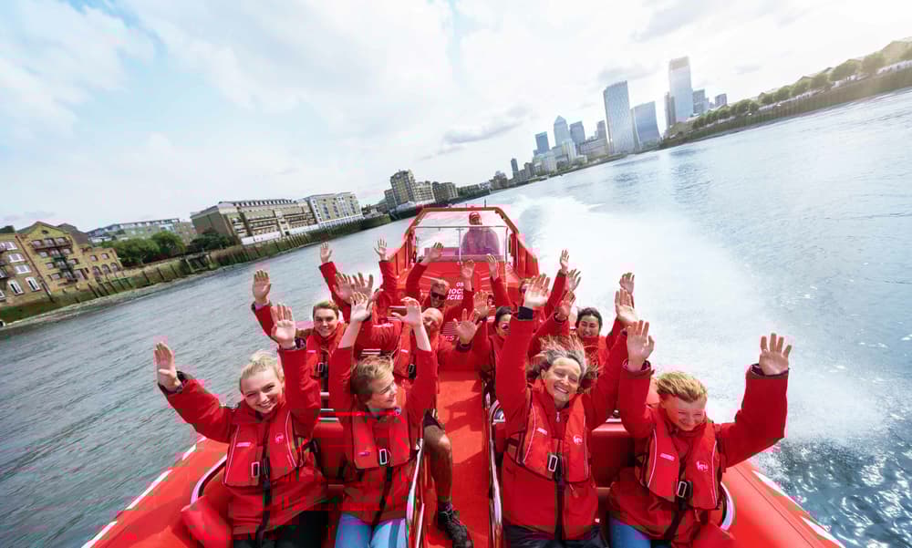 happy passengers with their arms in the air on a thames rockets break the barrier speedboat experience on the thames