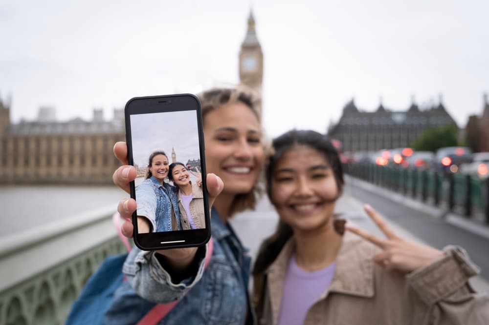 Front view smiley women with smartphone