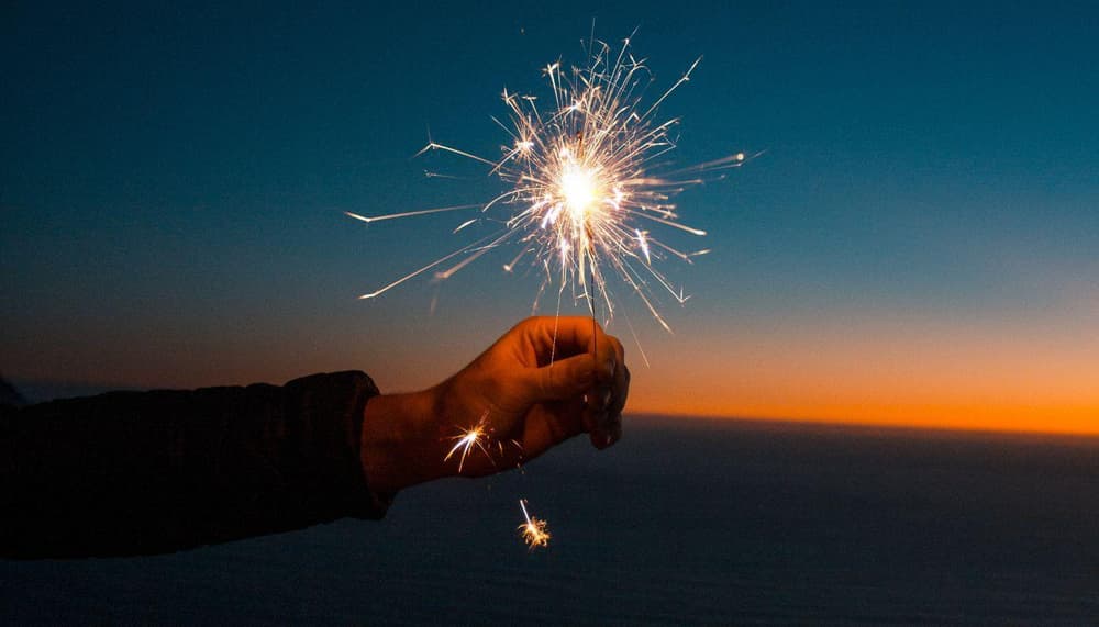 Hands holding sparklers in the air