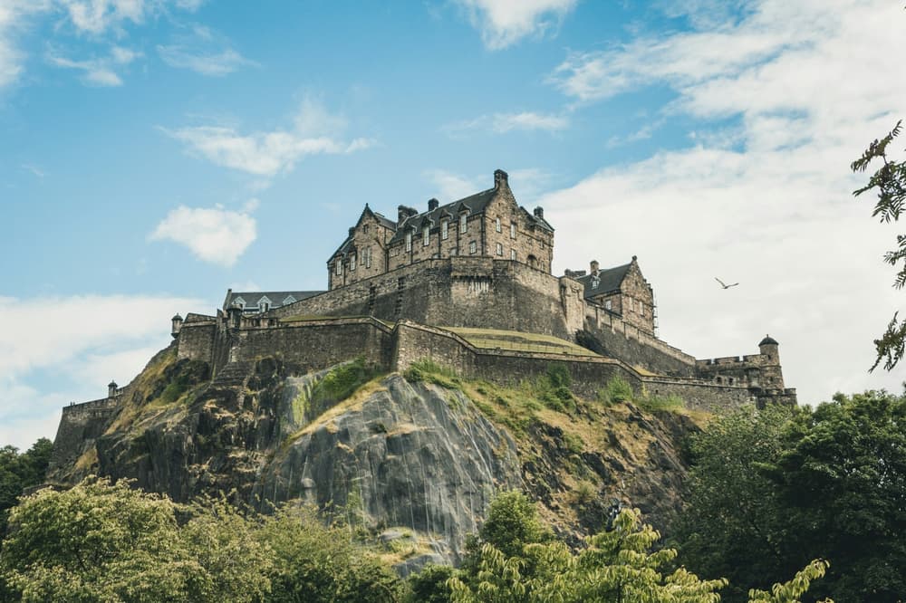 stately building on top of a hill against a cloudy blue sky