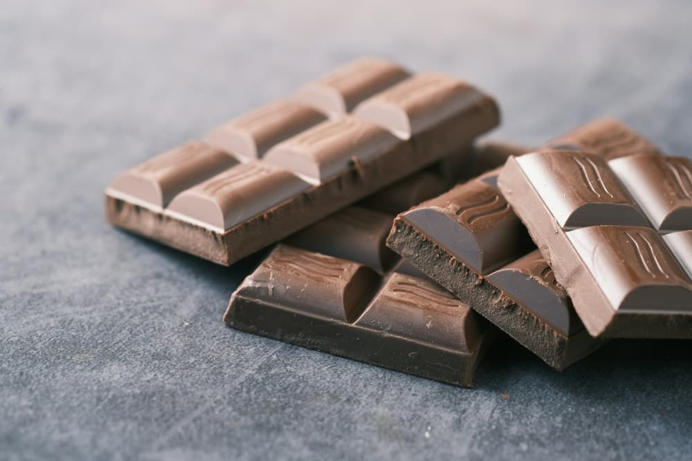 unwrapped vars of chocolate on a grey surface