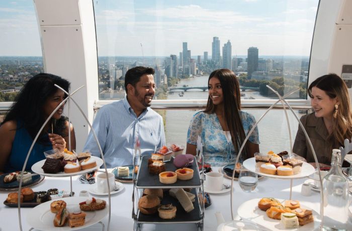 Four people around a table having afternoon tea on the london eye