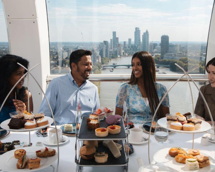 Four people around a table having afternoon tea on the london eye