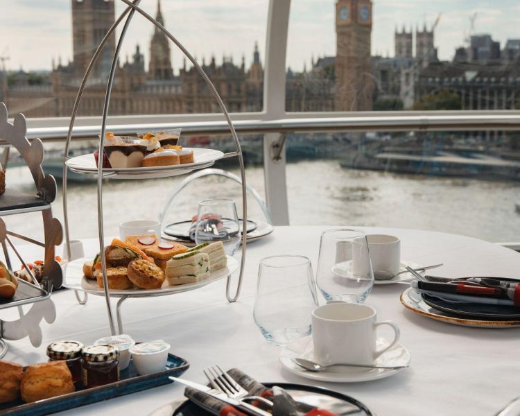 Afternoon tea on a table looking over london on the london eye