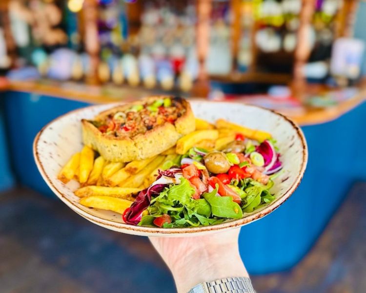 Mediterranean tart with fries and salad