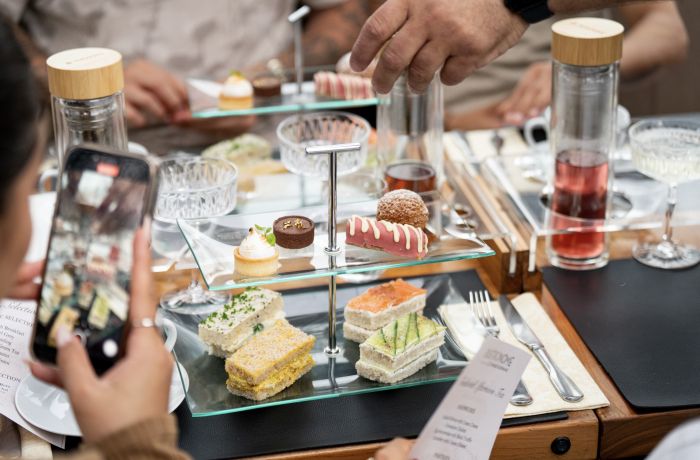 cake stand on table for afternoon tea on bustronome london