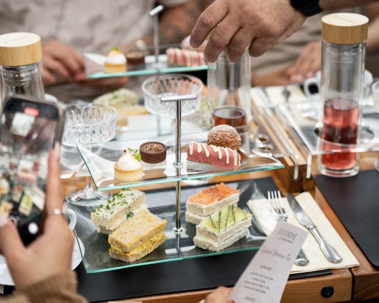 cake stand on table for afternoon tea on bustronome london