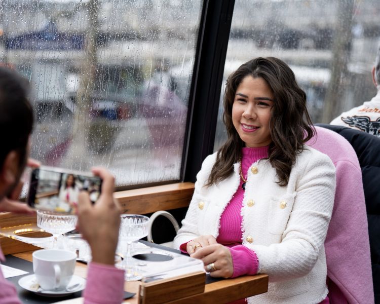 man taking photo of wife at afternoon tea on bustronome bus