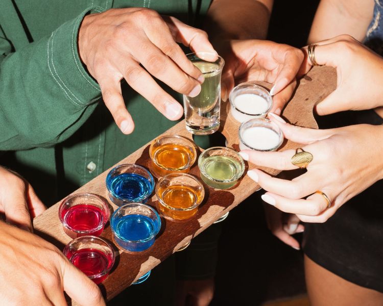 people taking shots at revolution bars