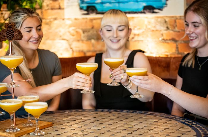 three ladies with a pornstar rumtini cocktail tree at revolucion de cuba