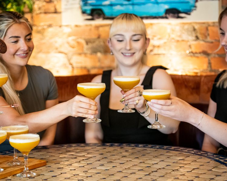 three ladies with a pornstar rumtini cocktail tree at revolucion de cuba