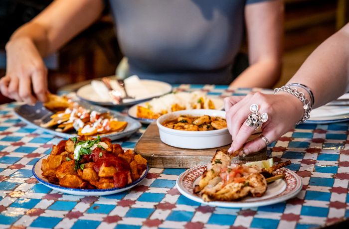 ladies eating tapas dishes at revolucion de cuba