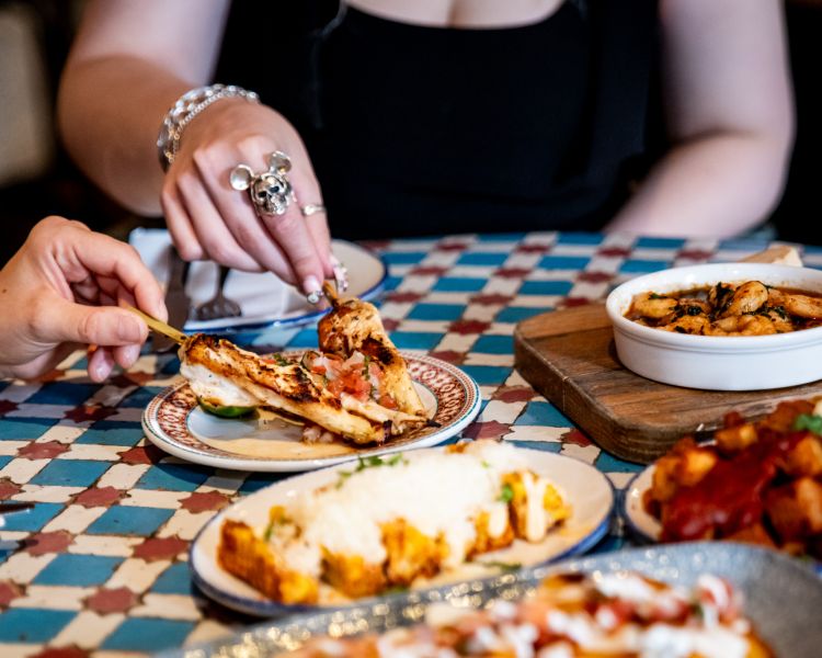 ladies eating tapas dishes at revolucion de cuba