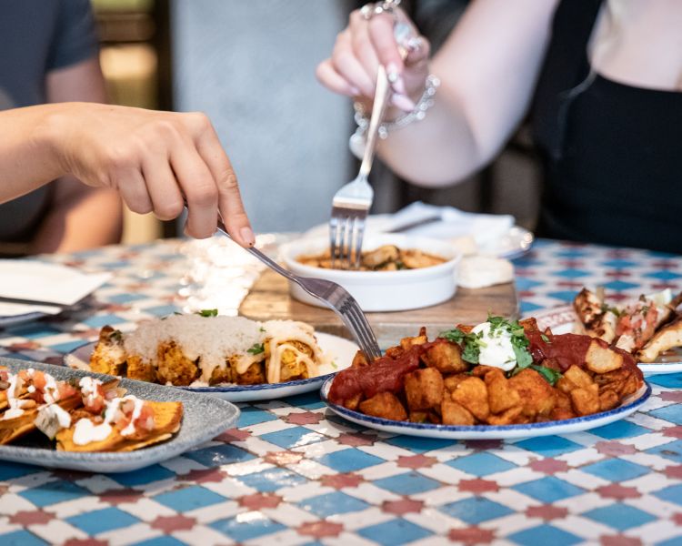 ladies eating tapas dishes at revolucion de cuba