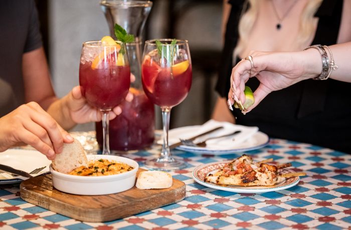 two ladies with jug of sangria and tapas at revolucion de cuba