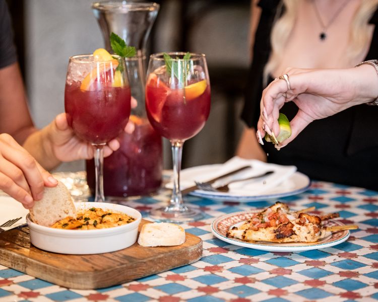 two ladies with jug of sangria and tapas at revolucion de cuba