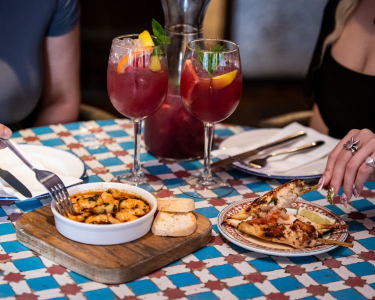 two ladies with jug of sangria and tapas at revolucion de cuba