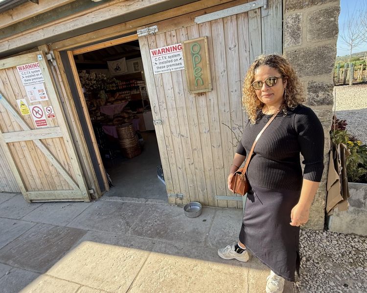 woman standing by entrance to farm shop on clarkson's farm