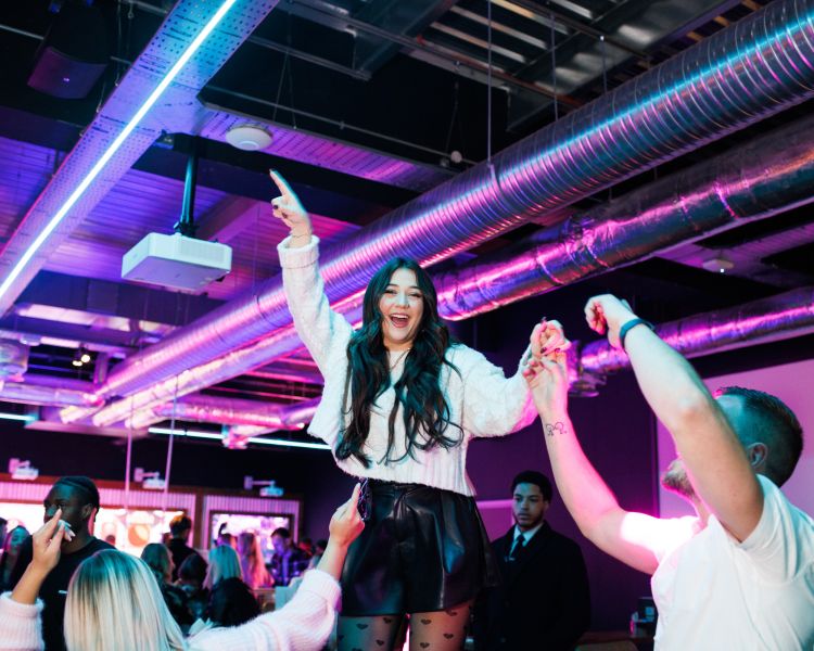 woman dancing on table at a boom battle bar