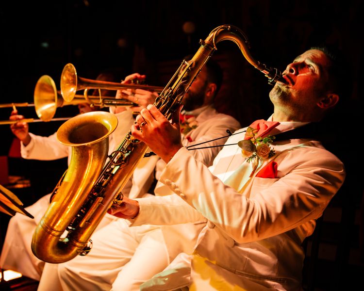 man playing saxophone in the band at the 58th Street immersive experience in london