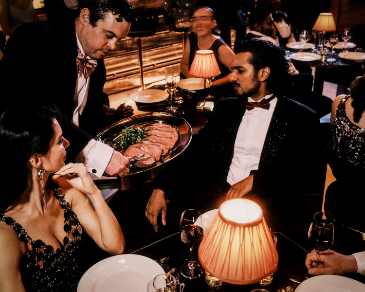 couple being served a 6 course meal at the 58th Street immersive experience in london