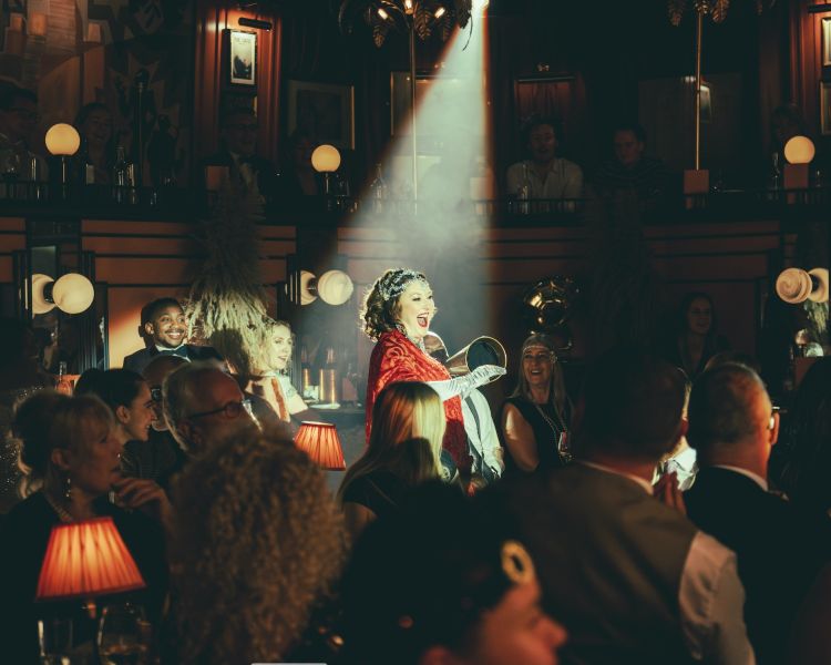 spotlight on the singer on stage at the 58th Street immersive experience in london