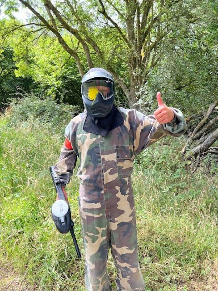 Person with thumbs up and paint on helmet